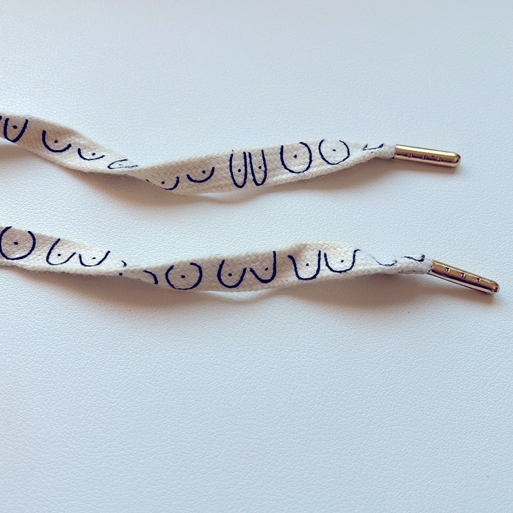 New white/cream printed novelty shoelaces breasts boobs with gold colored tips